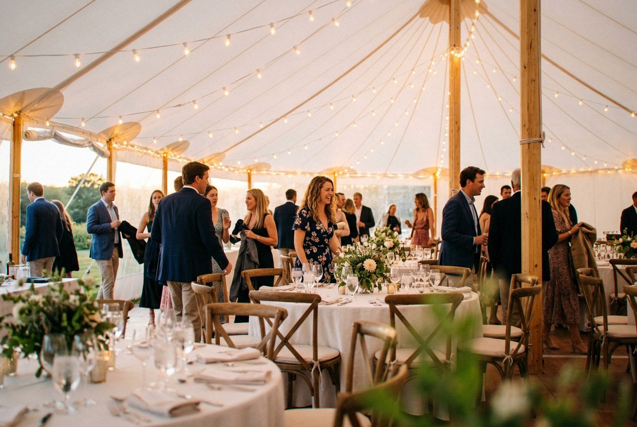 A string-lit pole tent glowing at dusk for an evening reception rented from Verbena Party Rentals in Miraflor